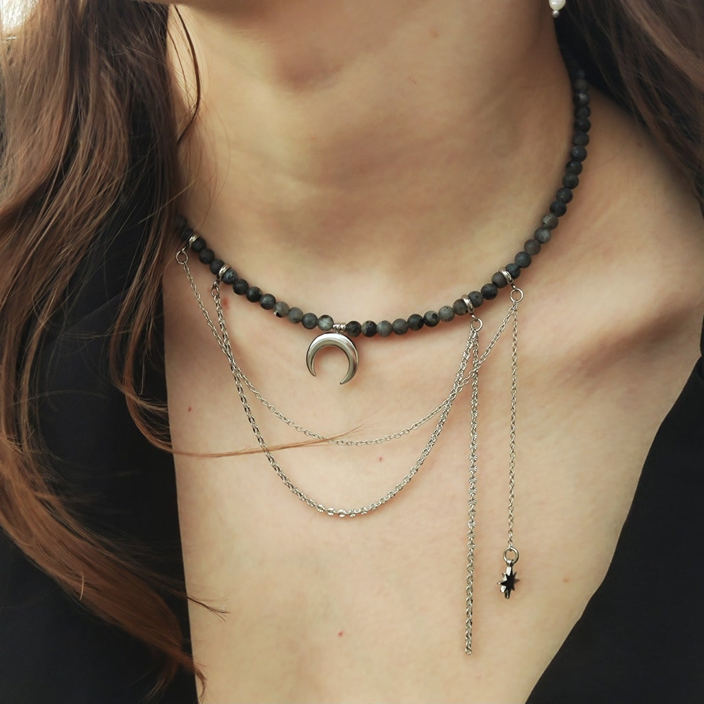 Handmade natural grey Labradorite beaded choker necklace on a model, featuring a central silver crescent half-moon pendant and delicate cascading silver chains with a small star charm.